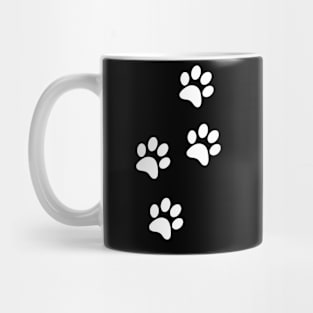White Paw-prints on a black surface Mug